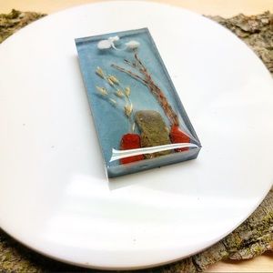 Handmade pendant arrangement with grass and stones